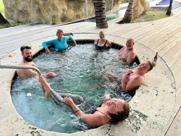 A group of people in an outdoor pool.