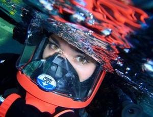 A person in a helmet and goggles looking into the camera.