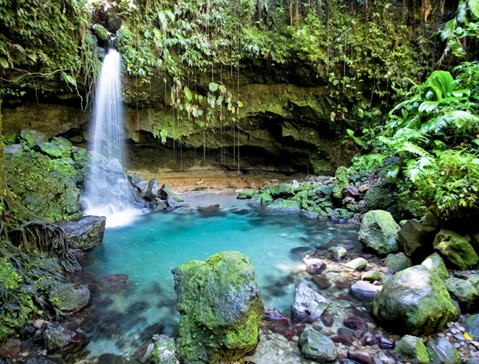 Waterfall cascades into a turquoise pool.