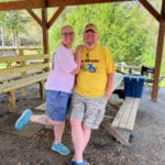 Couple smiling in a park pavilion.