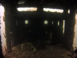 Underwater view of a sunken ship's interior.