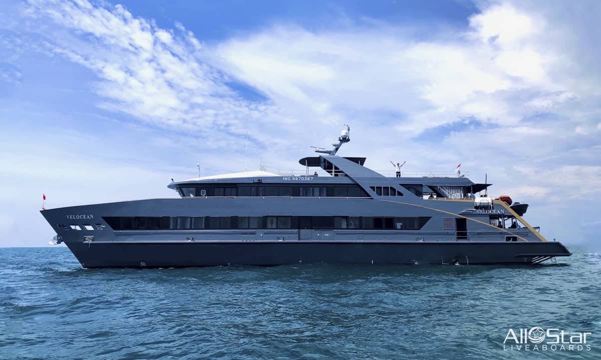 Grey yacht sailing on the ocean.