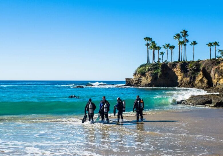 A group of people standing on top of a beach.